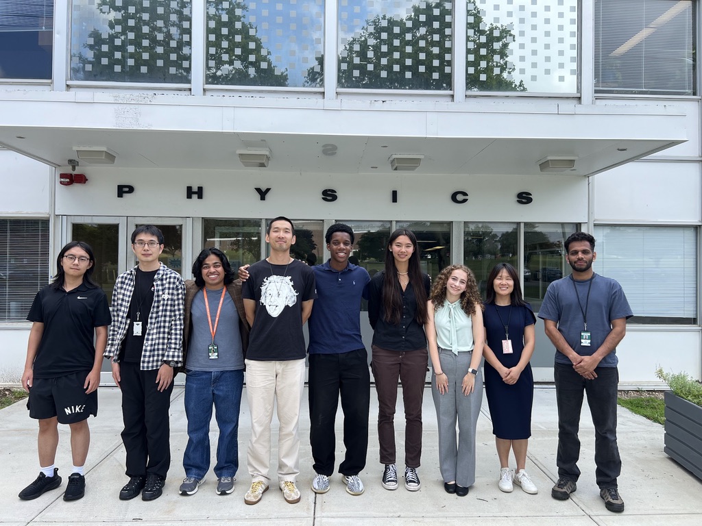 Rojae Mighty standing with his 2026 SULI research group outside the Physics building at Brookhaven National Laboratory